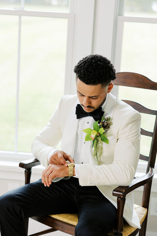 2. Groom adjusting his watch during getting ready portraits before Barbara and Gustavo’s wedding day