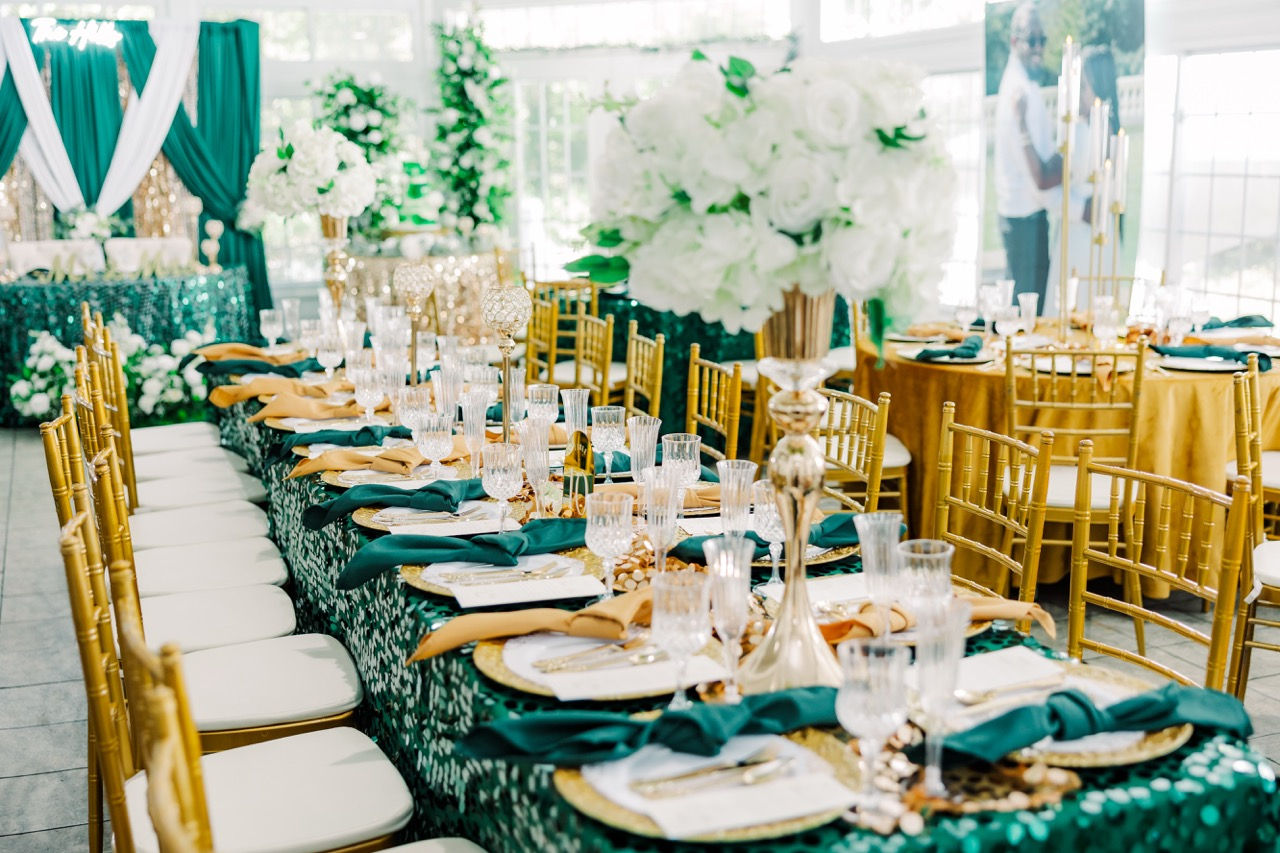 	3.	Close-up of wedding table setting with gold chargers, crystal glassware, and menu cards.