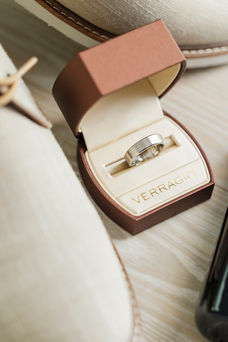4. Close-up of groom’s wedding ring displayed in a sophisticated leather ring box.