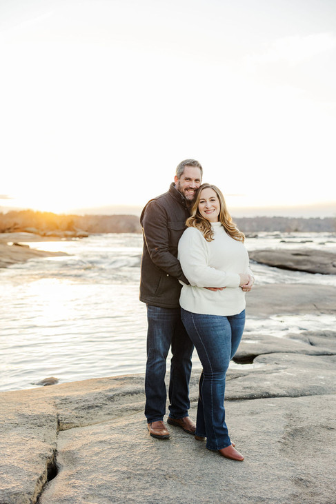 	1.	Engaged couple standing together on the rocks at Belle Isle during a Richmond engagement session
