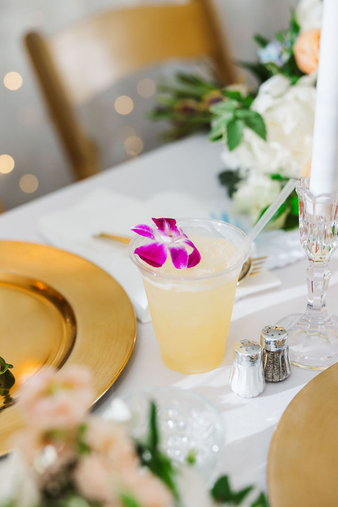 	5.	Signature cocktail with orchid garnish and gold charger plate