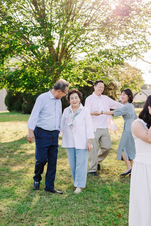 Three generations of the Lee family hugging and smiling together in the garden at Maymont Park.