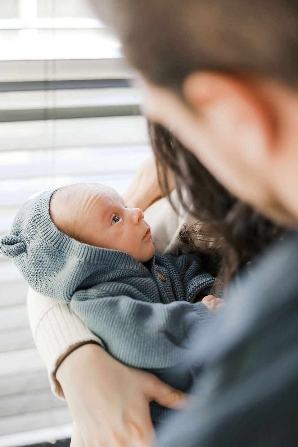 Mother holding her newborn baby boy during a calm lifestyle newborn photography session in Richmond VA