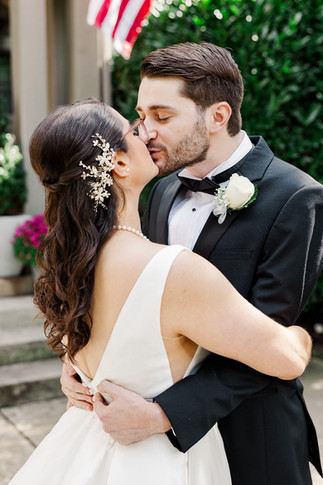 Bride and groom sharing a romantic kiss on their wedding day in Richmond, VA.