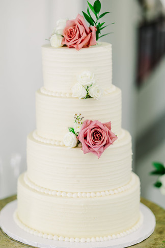 14. Close-up of blush rose on white wedding cake — fine-art dessert photo from The Dominion Club in Richmond.