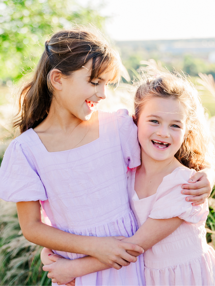 Sisters laughing and hugging during a photo session in Richmond, VA.
