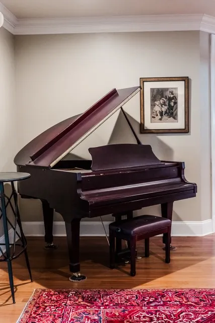 	2.	Grand piano in a softly lit room with wooden floors, adding a classic touch to The Mill at Fine Creek’s wedding venue.