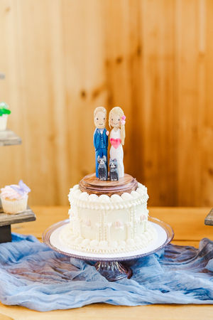 9. Wedding cake with custom cat-themed figurine topper