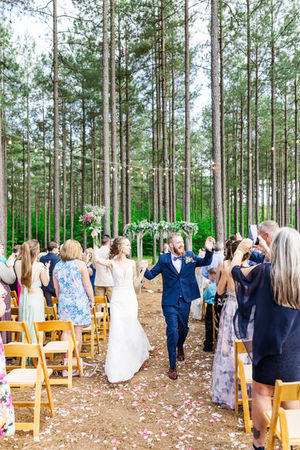 10. Guests celebrating after wedding ceremony under pine trees
