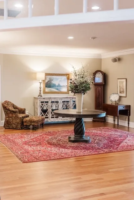 	7.	Spacious sitting room with vintage decor, plush seating, and a grand mirror at The Mill at Fine Creek.