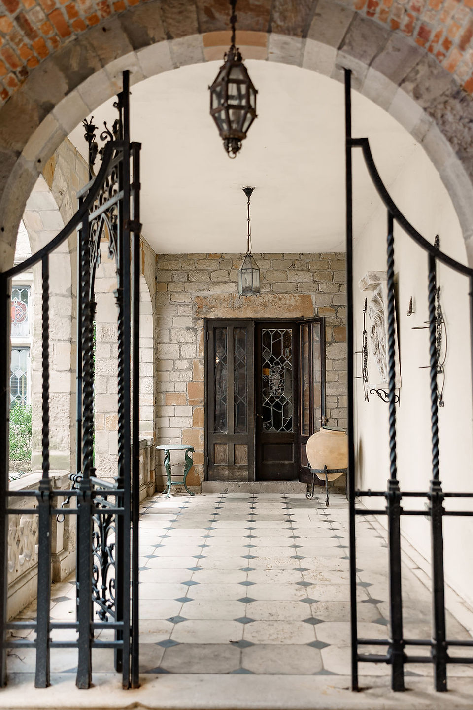 	2.	Elegant front entrance of Virginia House with black iron gates and checkered floors