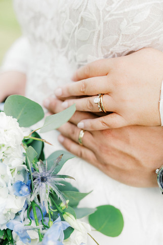 24. Bride and groom wedding rings detail with spring flowers in Lunenburg VA