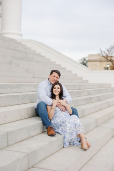 7. Couple sitting on Capitol steps smiling, with soft blue and white spring outfits