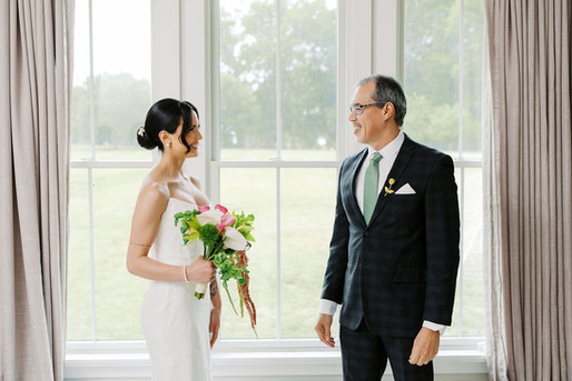 27. Bride and father smiling together after their first look before Barbara and Gustavo’s wedding ceremony