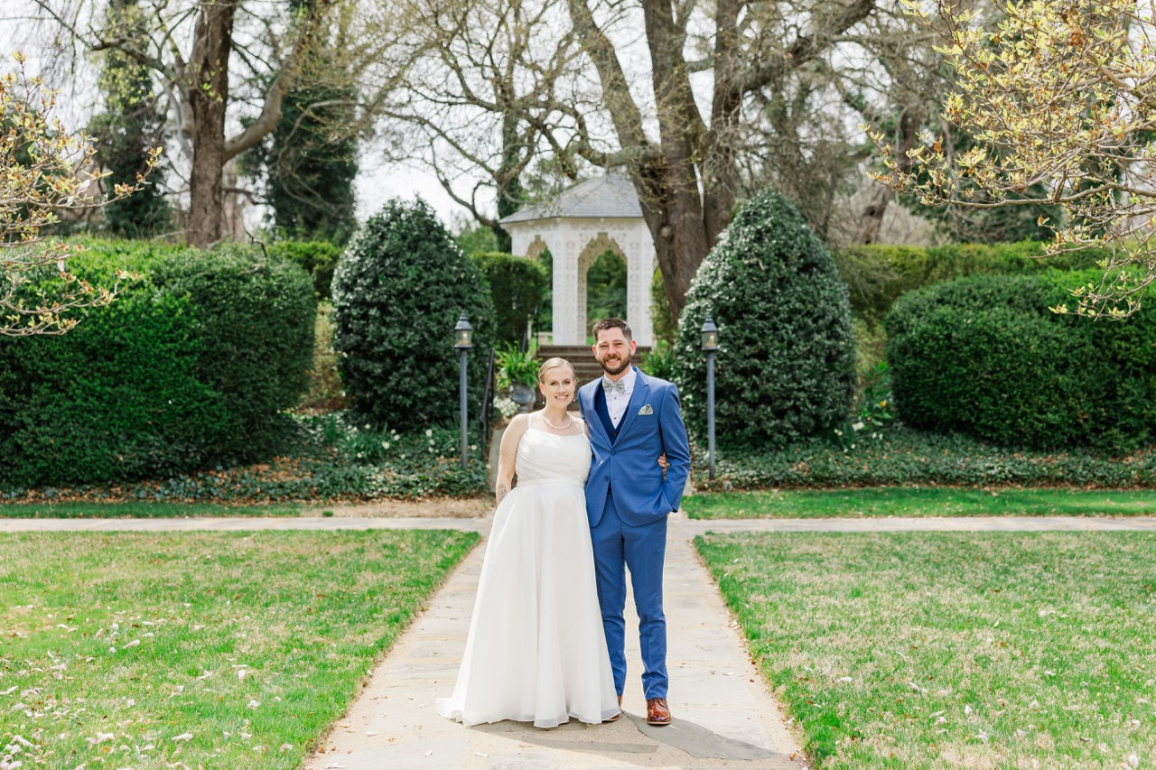 	14.	Bride and groom holding hands on garden path with gazebo
