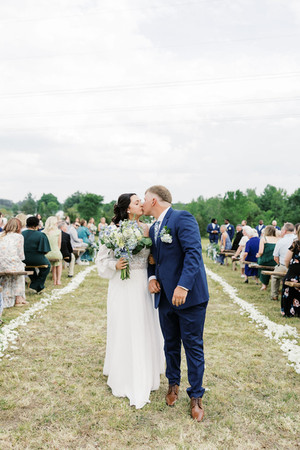 16. Newlyweds kissing in the aisle at Foxrun Venue & Events wedding