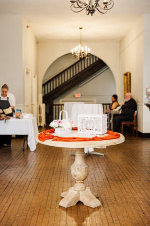 Wedding welcome table with a guestbook and floral accents at The Schoolhouse at Hawthorne in Richmond, VA.