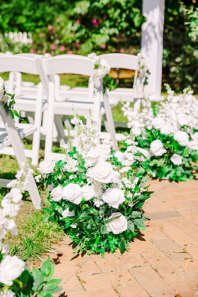 	5.	Wedding ceremony aisle lined with white flowers and greenery at Wrexham Hall.