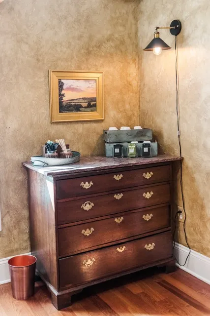 	9.	Vintage wooden dresser with bottled water and refreshments set up for wedding guests at The Mill at Fine Creek.