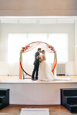 Bride and groom sharing their first kiss as husband and wife at The Schoolhouse at Hawthorne in Richmond, VA.