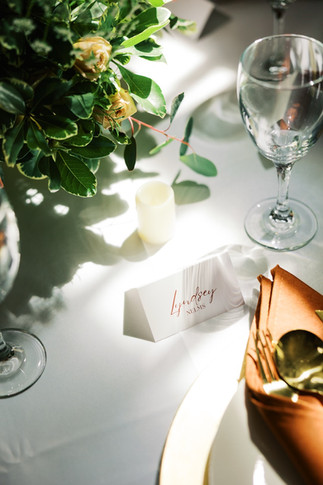 50. Wedding place setting with champagne napkin and floral centerpiece