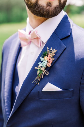 15. Groom’s suit with soft pink bow tie and boutonniere