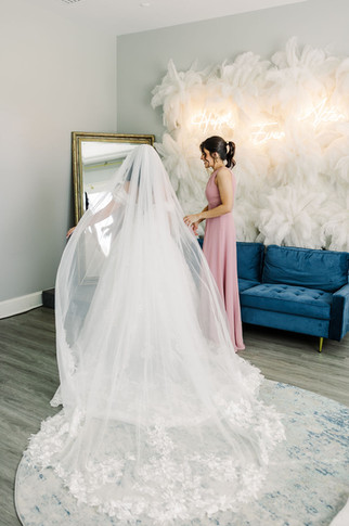 17. Bride looking at her wedding gown before putting it on — emotional pre-ceremony moment captured in Richmond, VA.