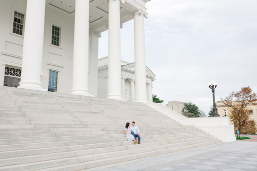 6. Wide-angle view of couple walking in front of grand columns at the Virginia Capitol