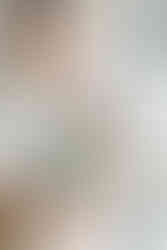 Close-up of a father holding his baby close, capturing a quiet moment during an at-home newborn photography session in Richmond, Virginia.