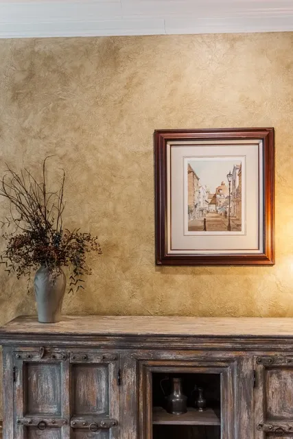 	17.	Close-up of a ceramic vase with dried floral arrangements against a textured wall, adding a warm aesthetic.
