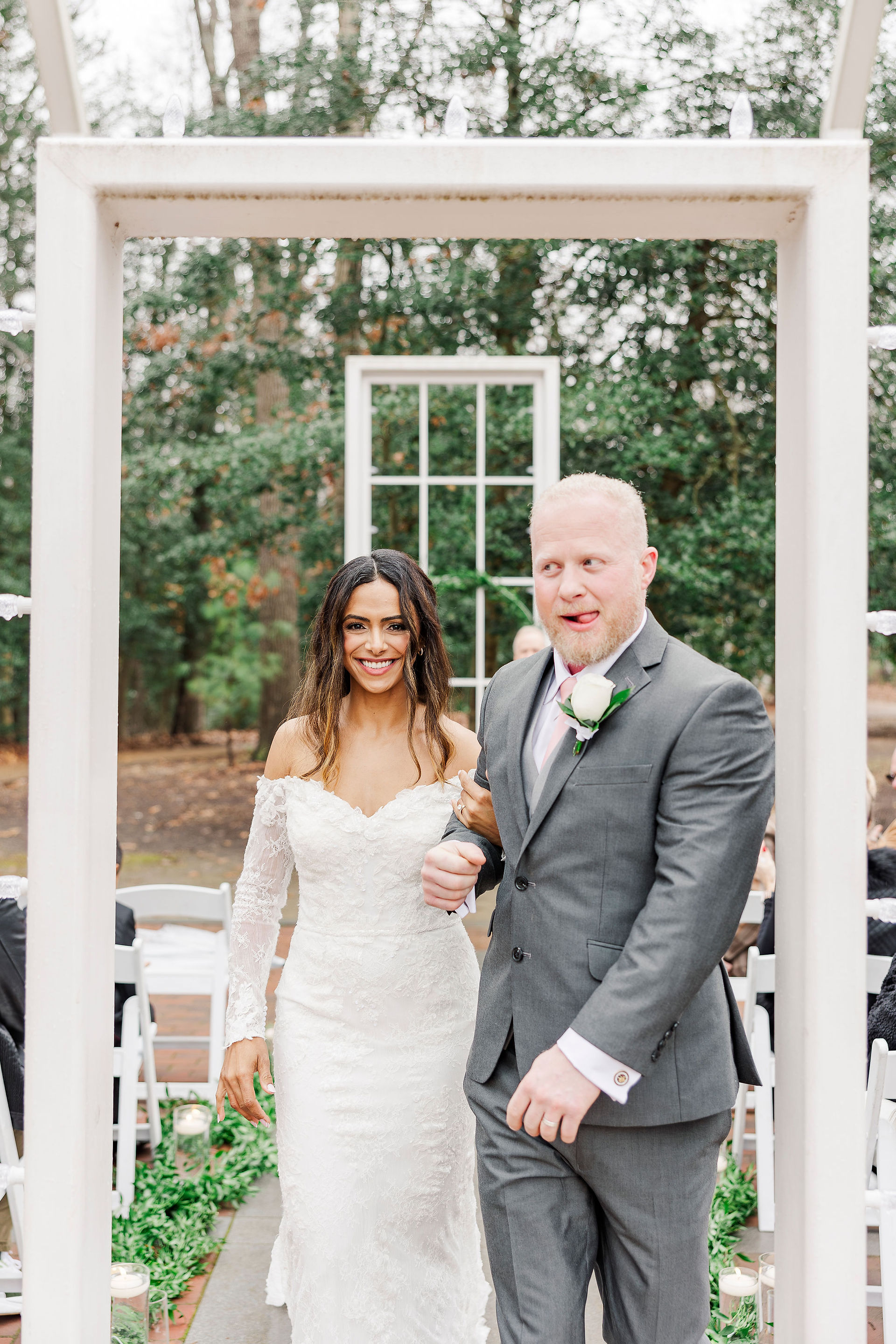 Bride and groom smiling as they exit their wedding ceremony at Polegreen Church in Richmond, VA.