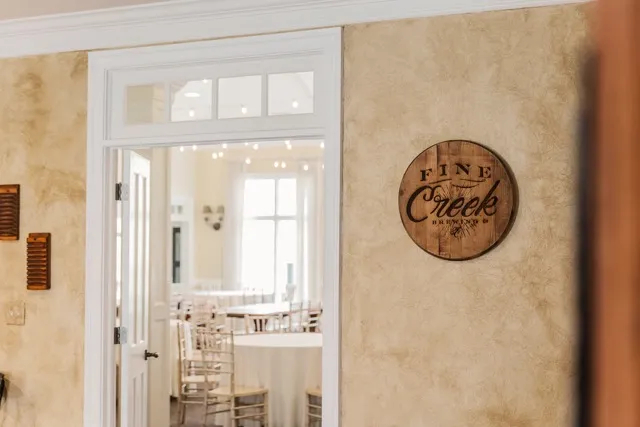 	13.	White-framed doorway leading to a cozy indoor wedding space with soft lighting.