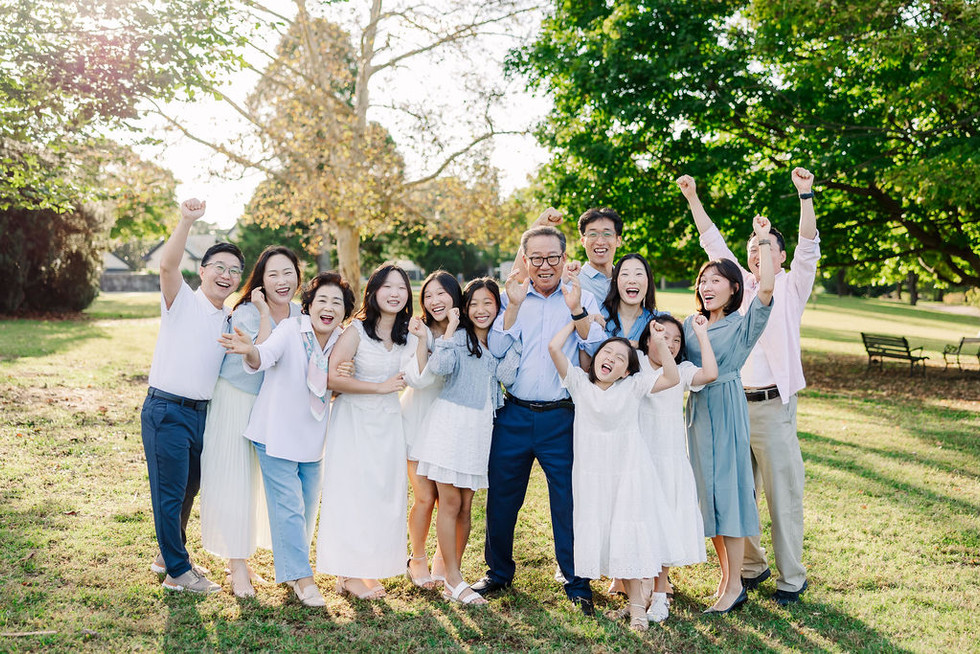 Candid shot of the Lee family walking and smiling in golden light at Maymont gardens.