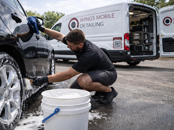Professional car wash process using foam pre-wash method in mobile detailing setup