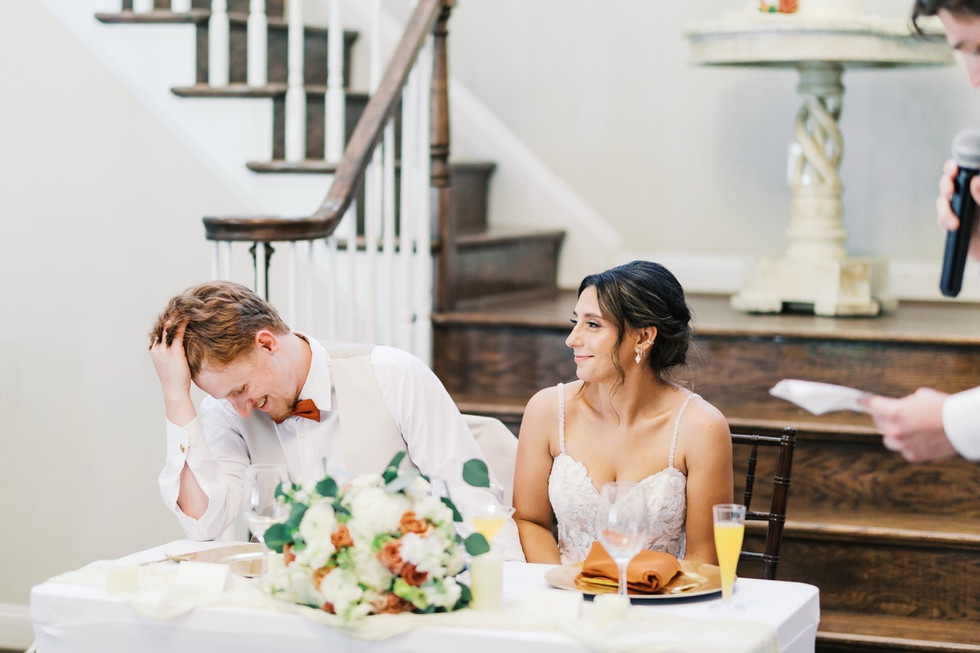 15. Bride and groom sitting at sweetheart table during Virginia wedding reception