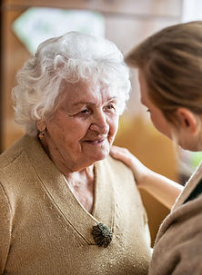 An elderly woman visits with her young female relative.
