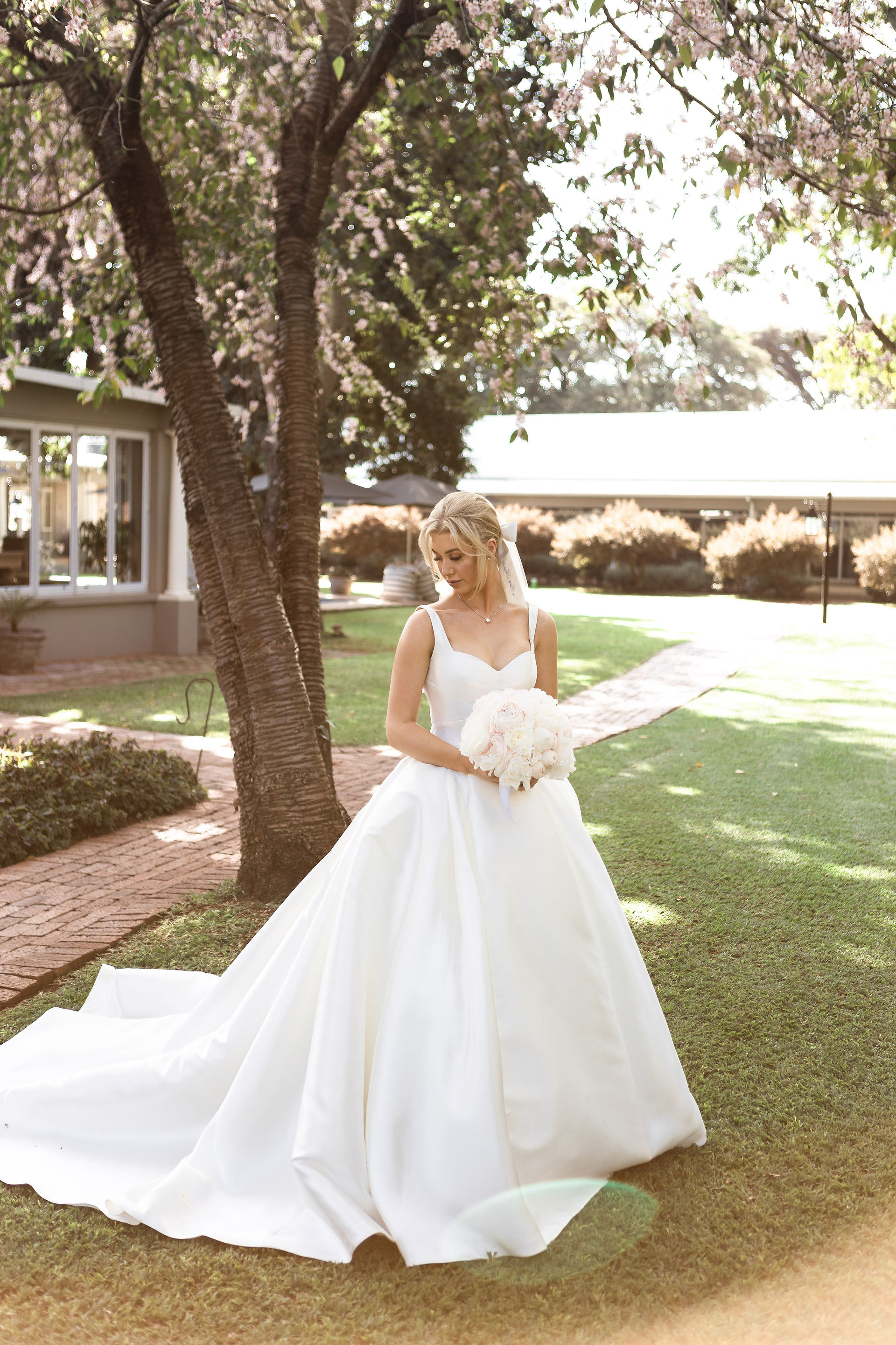 Bride holding bouquet in garden