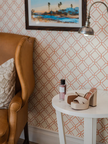 Christian Dior perfume bottle next to designer wedding shoes