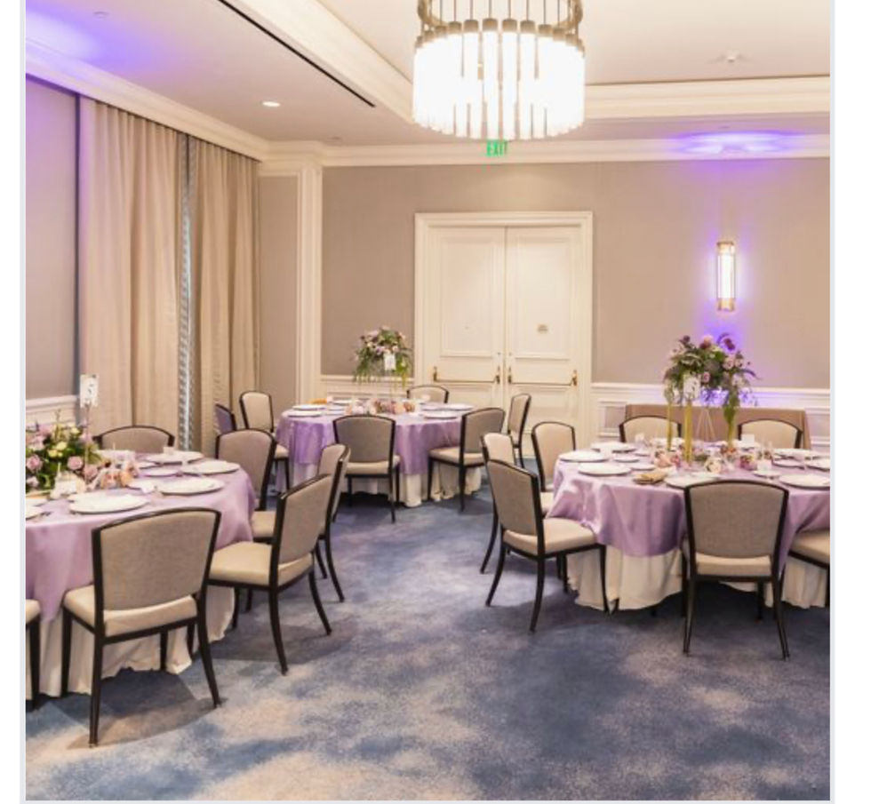 Special Events Table Floral Arrangements inside a conference room with pink place settings and beautiful centerpiece floral arrangements