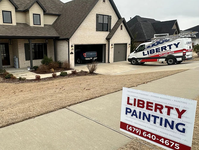 Professional residential painter from Liberty Painting Specialists applying interior paint in a Bentonville home, Northwest A