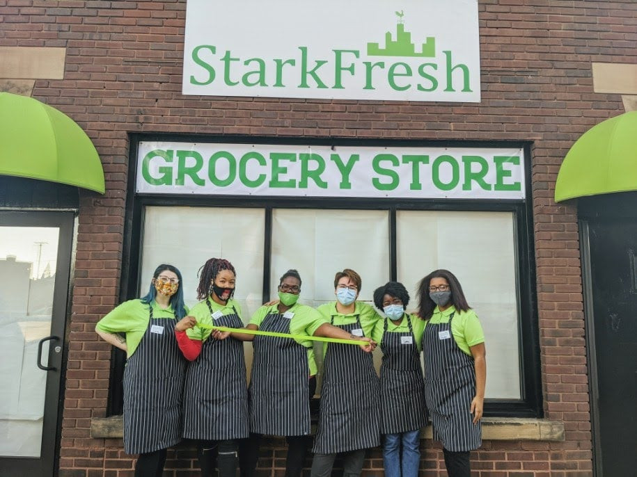Six employees stand in front of the storefront of StarkFresh Grocery Store in Canton, Ohio