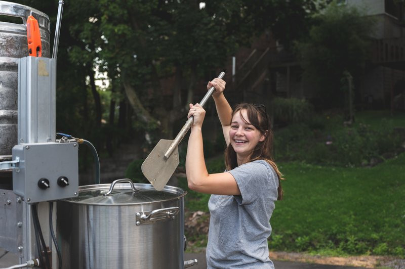Patricia McKinley, one of the co-owners of Back Alley Brewing in Dormont Pennsylvania, stirs some mash