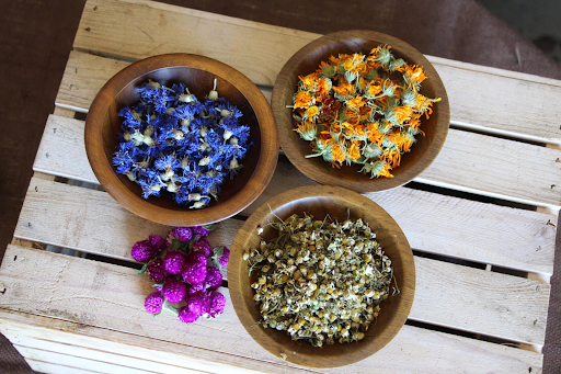 bowls of dried herbs and flowers for Cherry Valley Organics teas