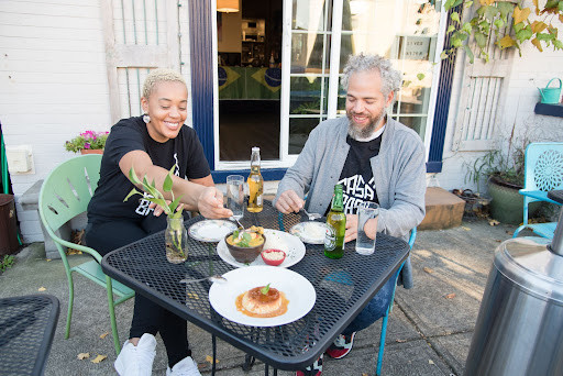 Casa Brasil owners Keyla and Tim enjoy a meal on the restaurant's patio