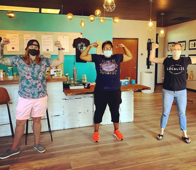 Kari and her friends flex in front of the counters they built themselves for the buildout