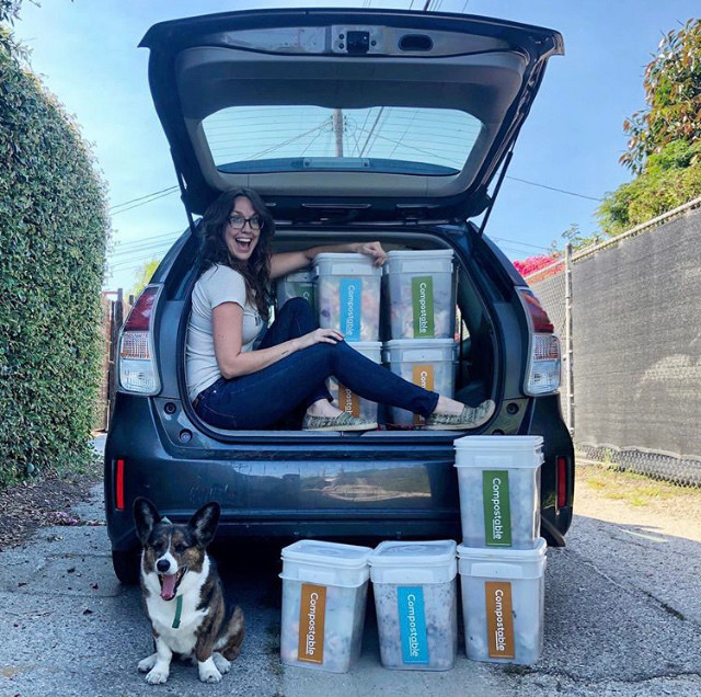 Monique Figueiredo, Compostable LA's founder, sits in the back of a Prius filled with buckets of compost