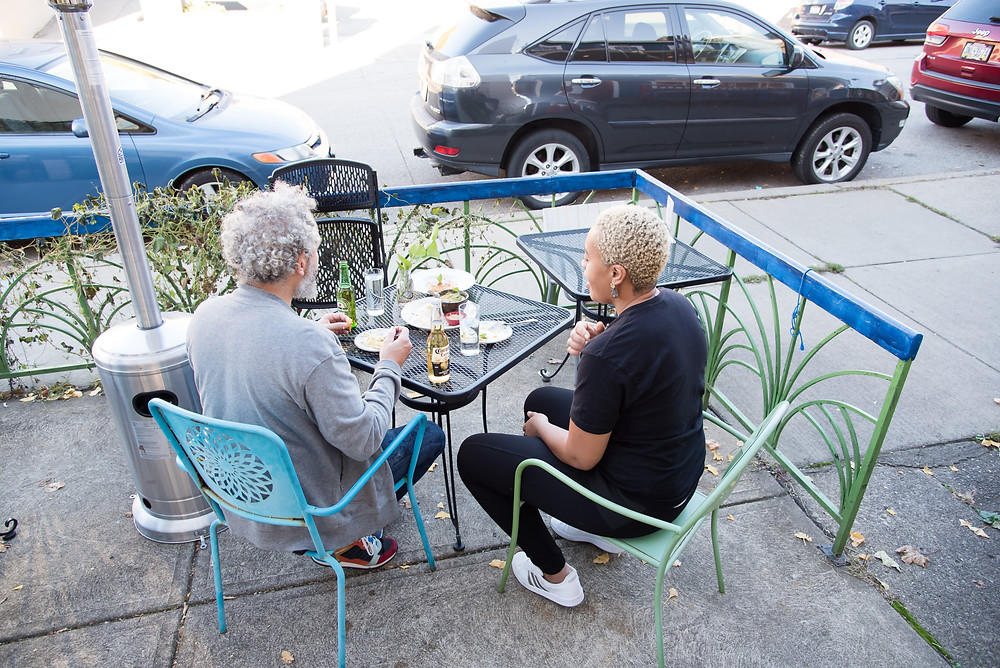 Keyla and Tim, owners of Casa Brasil restaurant in Pittsburgh, enjoy a meal on their patio