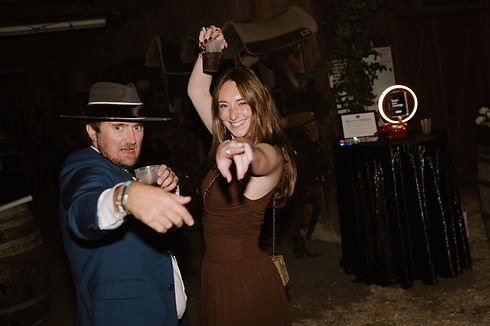 Two people point at the camera with Leave A Message in the background