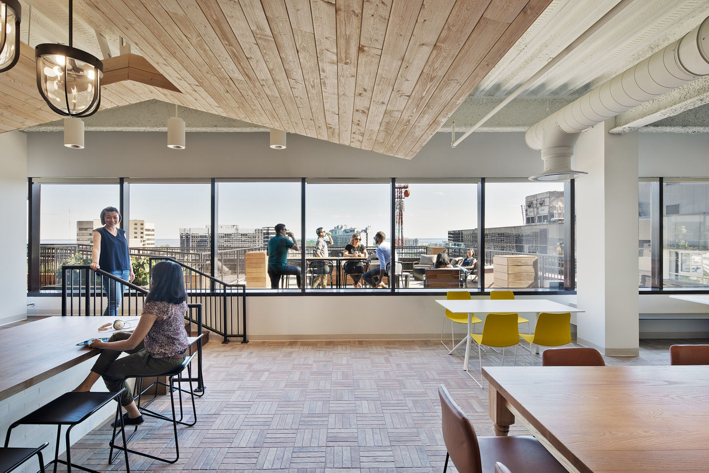 Lounge area of the Indeed office in Stamford, CT. Looking through the windows from the lounge area toward the rooftop deck. Design by Perkins + Will, photography by Ines Leong / L-INES Photo