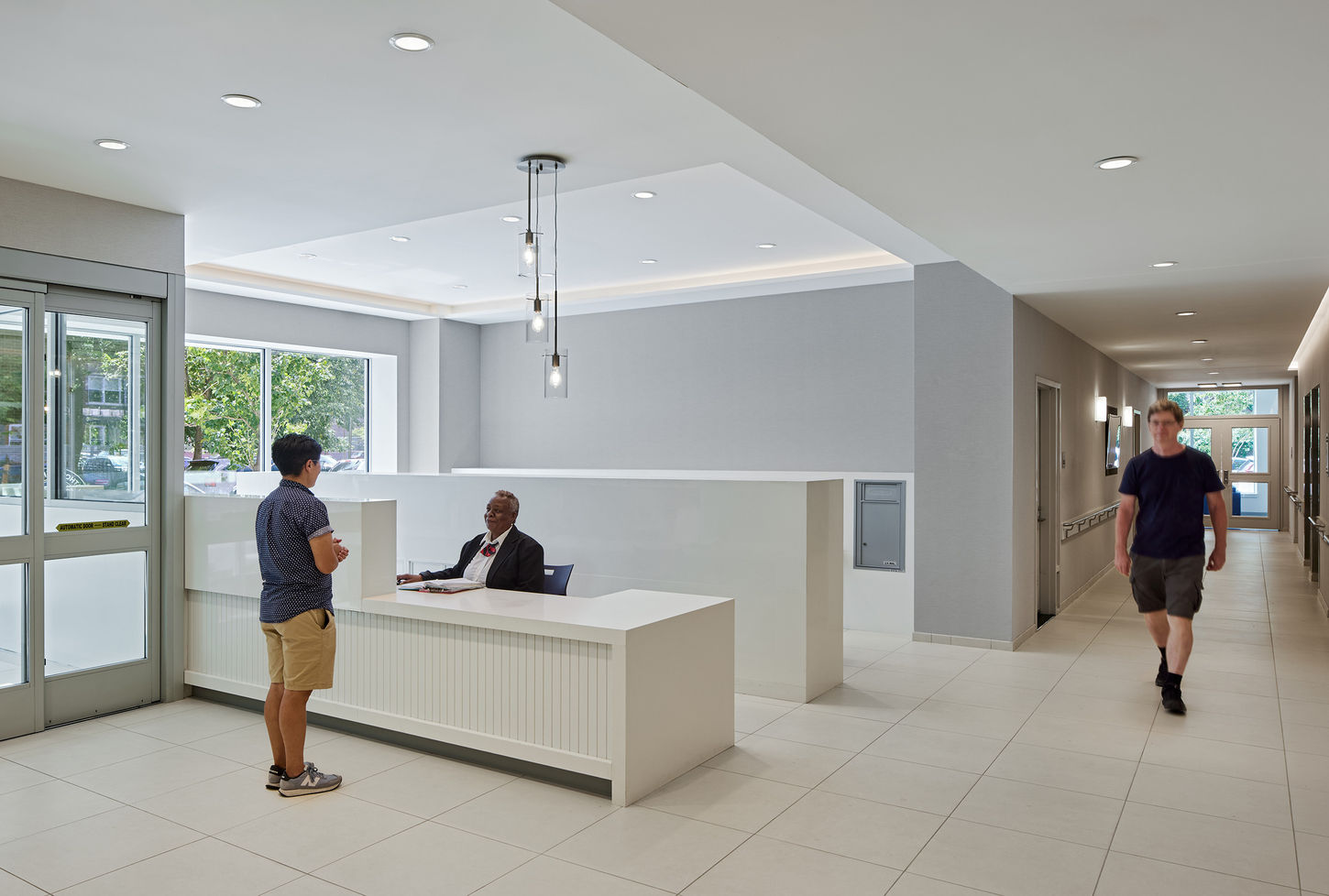 Reception area of the lobby with a security guard and a guest.